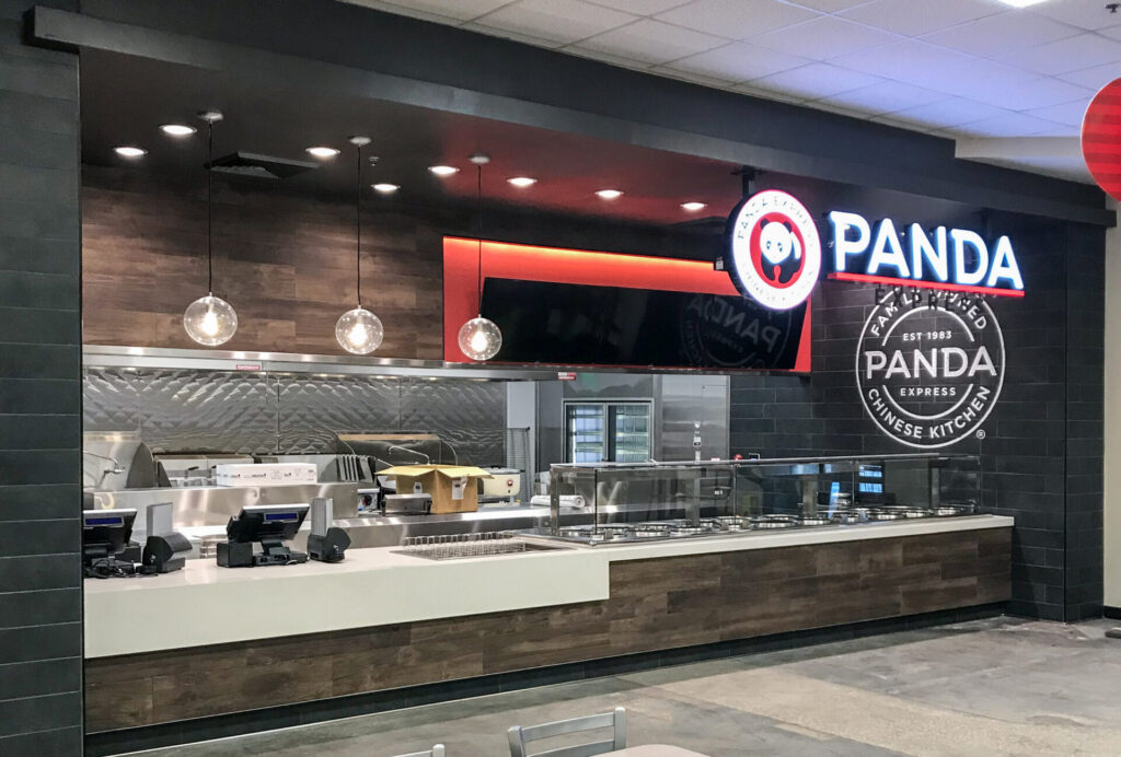 A Panda Express restaurant counter with a service line and branded signage.