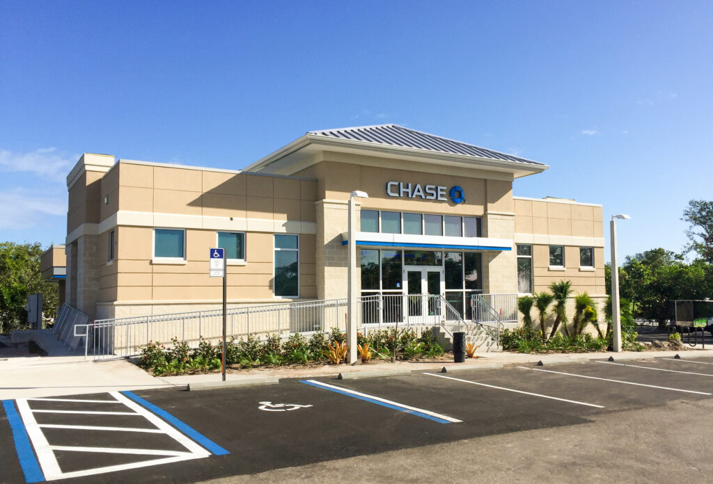 Chase bank branch building with a parking lot and accessible parking space in the foreground.