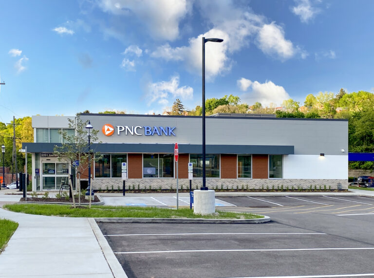 A PNC Bank branch building with a parking lot in the foreground.