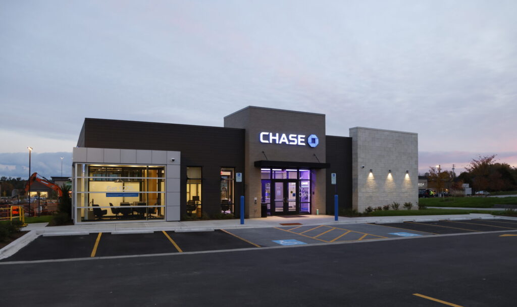 A Chase bank branch building with a parking lot in the foreground.