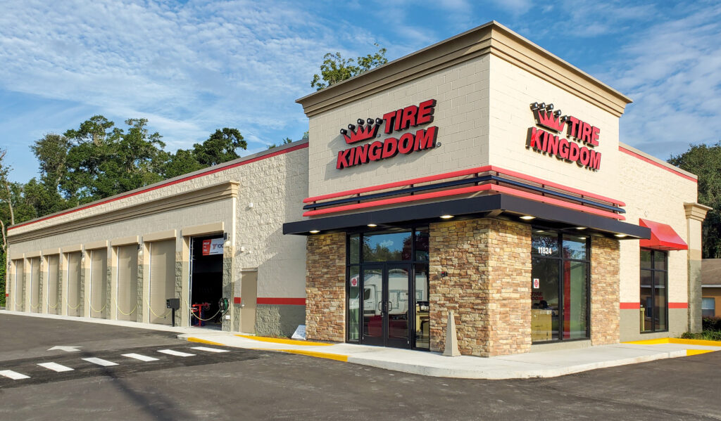Tire Kingdom auto service center building with multiple garage bays and a stone facade entrance.