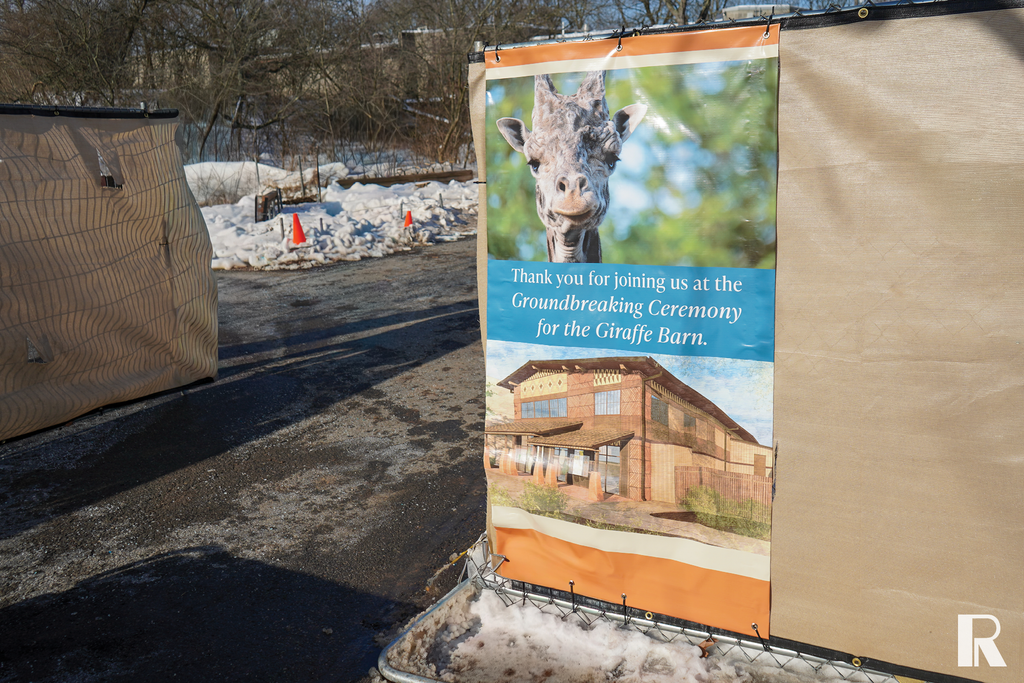 Banner showing a giraffe and an architectural rendering, with the text: “Thank you for joining us at the Groundbreaking Ceremony for the Giraffe Barn.”