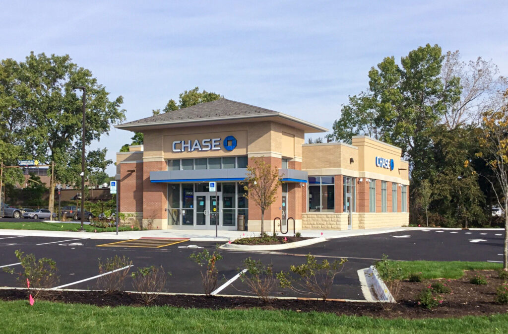 A Chase bank branch building with a parking lot in the foreground.