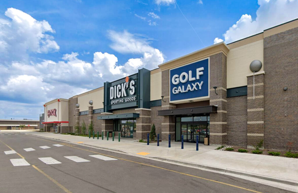 A strip mall storefront featuring a Golf Galaxy store, a Dick’s Sporting Goods, and a T.J. Maxx.