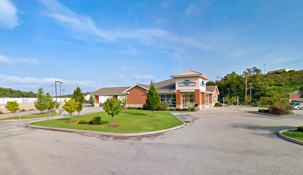 A Fifth Third Bank branch building with a red brick exterior and a drive-thru lane.